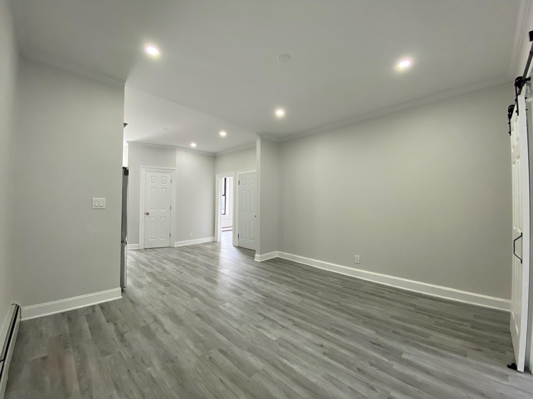338 2nd Street, Unit 2 Jersey City, NJ 07302 - Photo 2 of 9 a view of an empty room with wooden floor