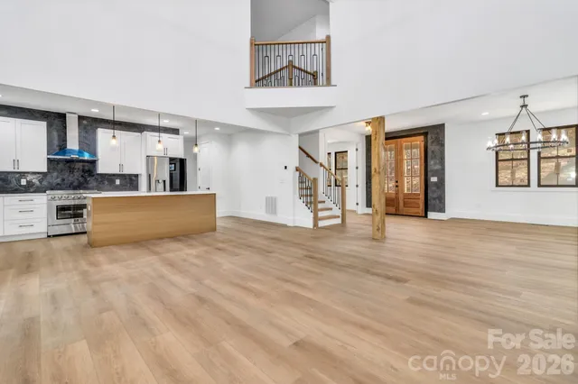 a view of a kitchen with furniture and wooden floor
