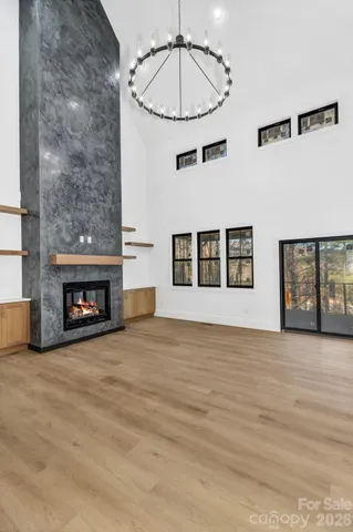 a view of an empty room with a fireplace and window
