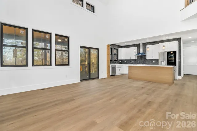 a view of a kitchen with a sink and a large window