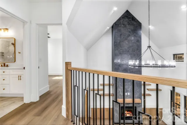 a view of staircase with white walls and railing
