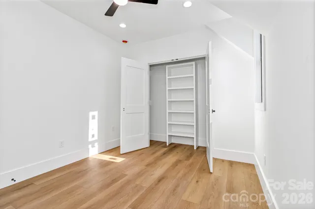 a bathroom with a bathtub shower sink vanity and toilet
