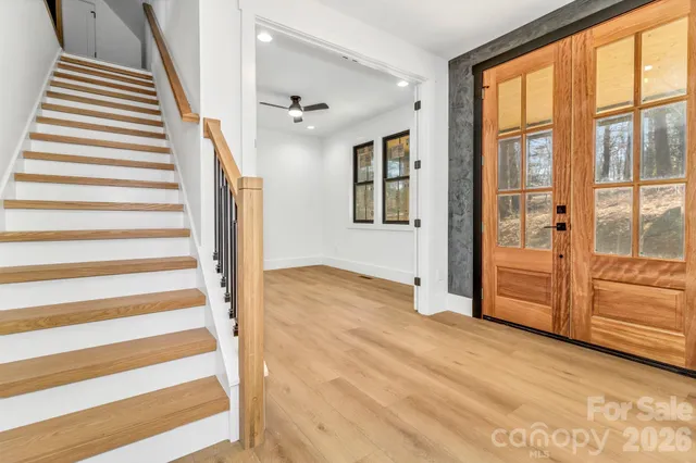 a view of an entryway with wooden floor and windows