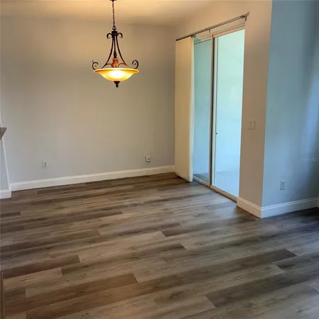 a view of a room with wooden floor and white walls