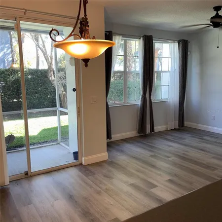 a view of a room with wooden floor and outdoor space