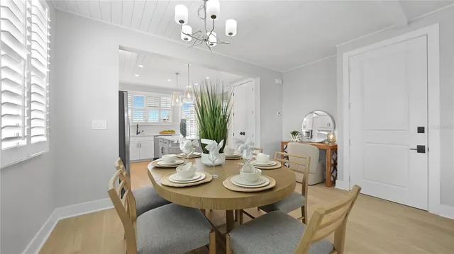 a view of a dining room with furniture and chandelier