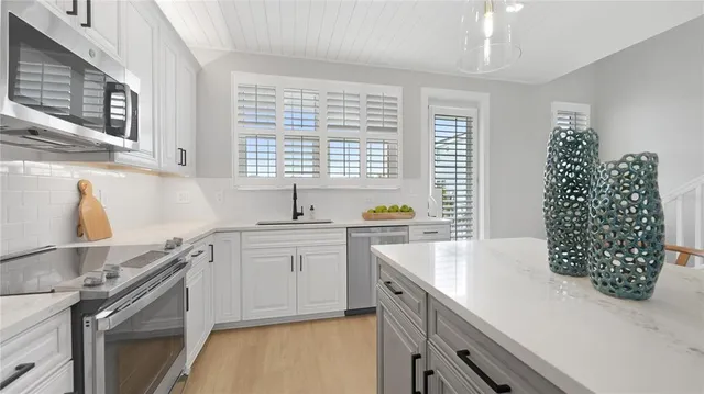 a kitchen with sink and cabinets