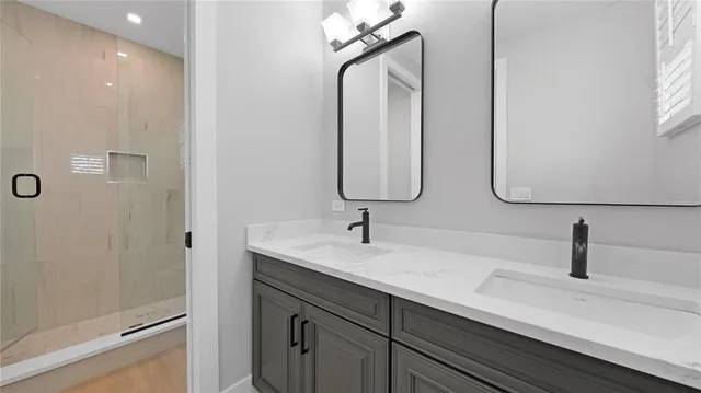a bathroom with a double vanity sink and a mirror