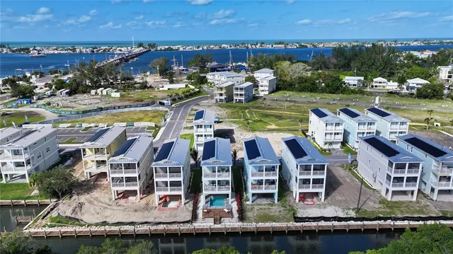 an aerial view of residential houses with outdoor space and swimming pool