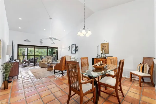 a dining room with furniture a rug and a chandelier