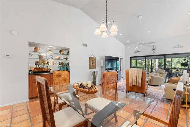 a living room with furniture a rug and a chandelier