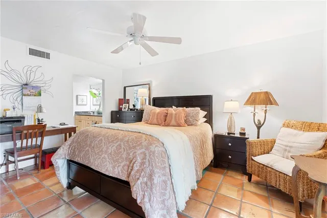 a bed room with a bed and a chandelier