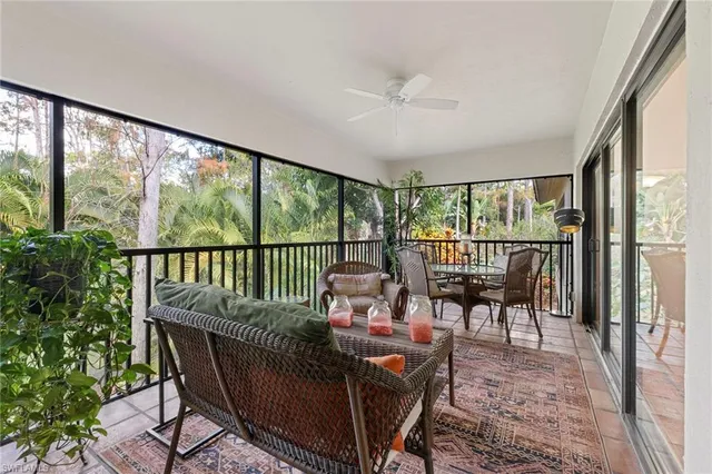 a balcony with furniture and a potted plant