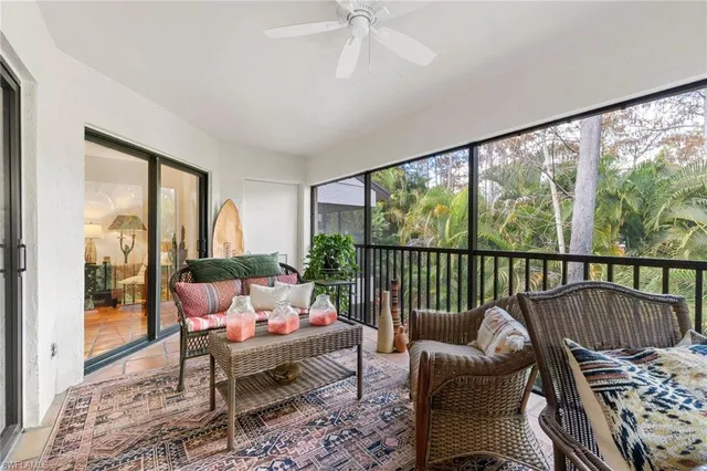 a balcony with furniture and a potted plant