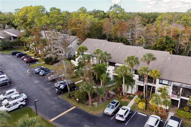 an aerial view of a house with a yard basket ball court
