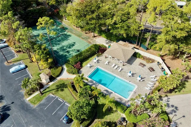 an aerial view of a house with a yard and blue swimming pool