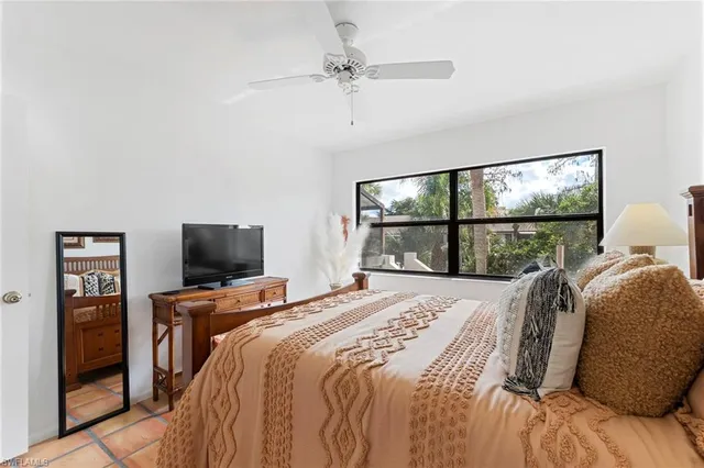 a bedroom with a bed and glass window
