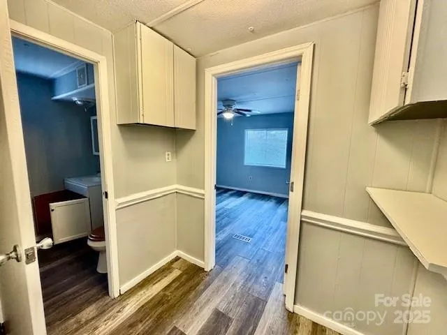 a view of a hallway with wooden floor