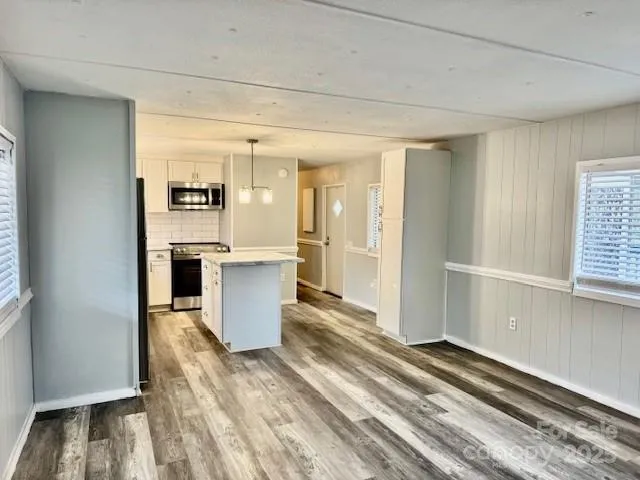 a kitchen with cabinets and wooden floor