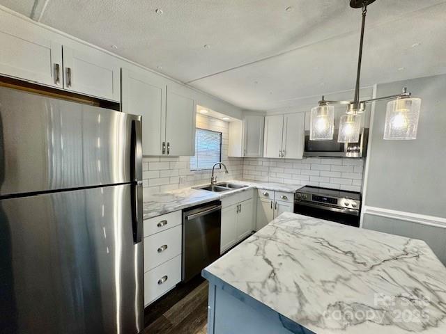 350 39th St Place Southwest Hickory, NC 28602 - Photo 9 of 19 a kitchen with stainless steel appliances a refrigerator sink and wooden floor