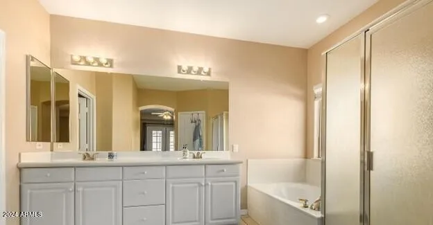 a bathroom with a double vanity sink and a mirror