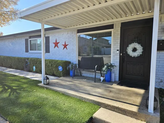 a view of a porch with a table and chairs