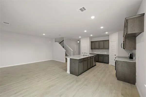 a view of a kitchen with a sink and a kitchen view