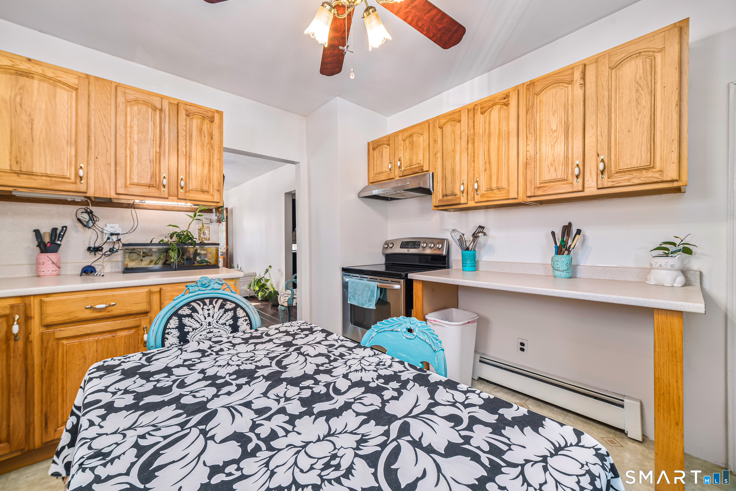 11 Willard Avenue Enfield, CT 06082 - Photo 14 of 30 a kitchen with stainless steel appliances a sink a stove a refrigerator cabinets and a window