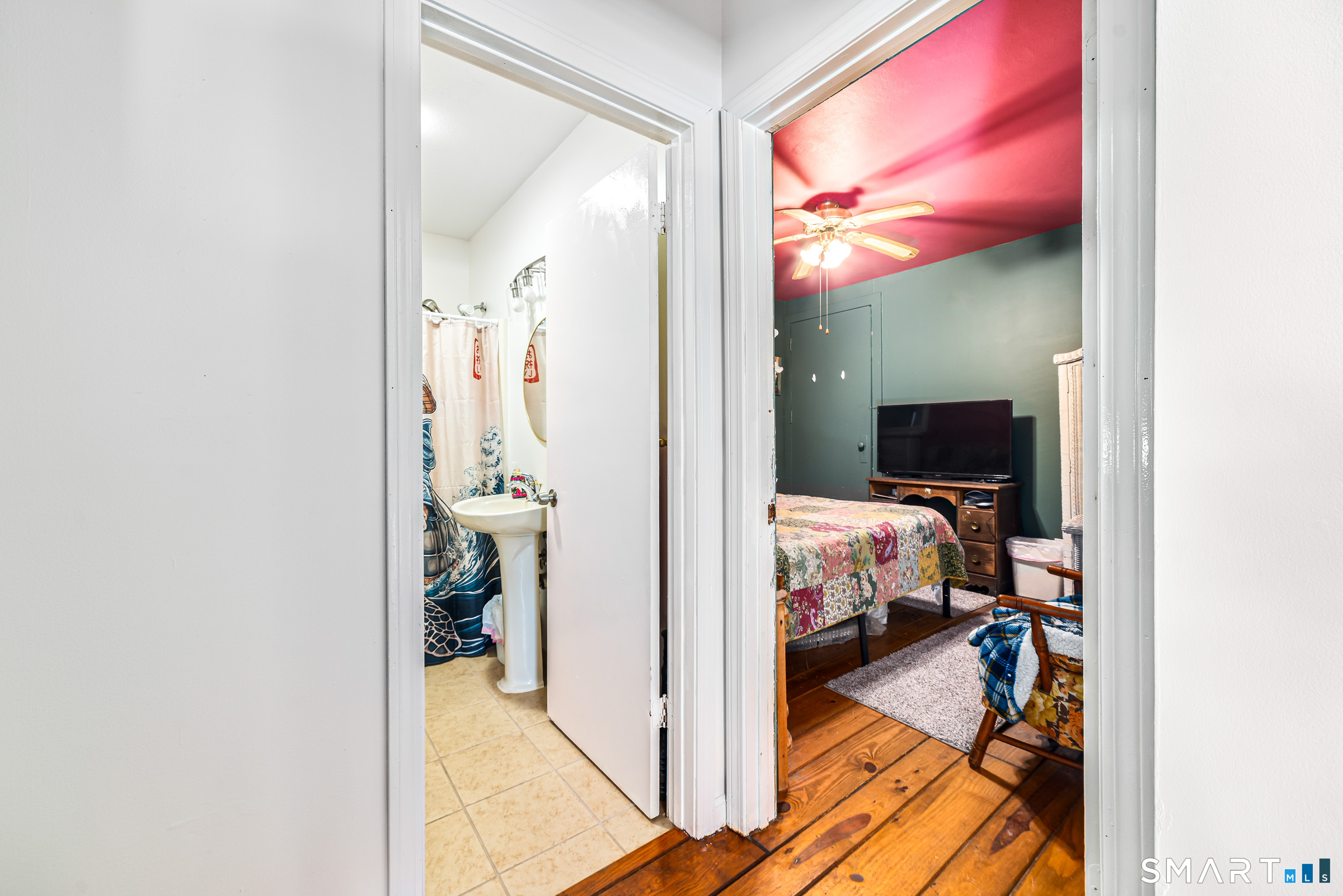11 Willard Avenue Enfield, CT 06082 - Photo 17 of 30 a view of a bedroom with a bed and a mirror