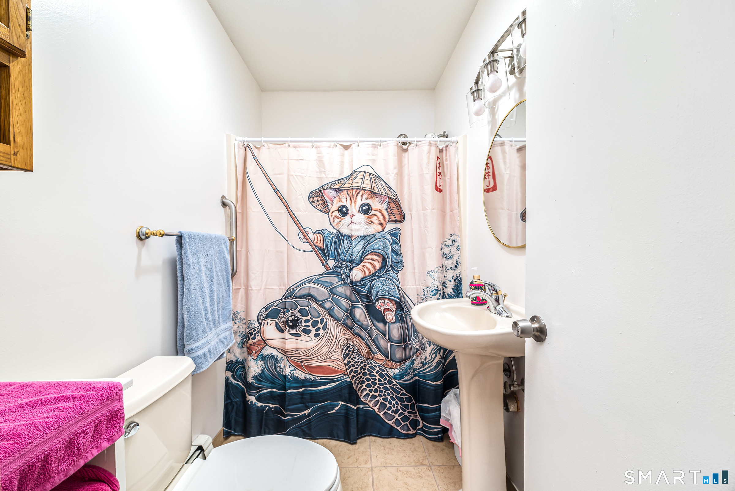 11 Willard Avenue Enfield, CT 06082 - Photo 18 of 30 a bathroom with a sink mirror vanity and toilet