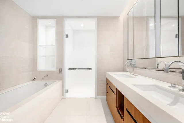 a spacious bathroom with a bathtub and a sink