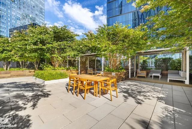 a view of a backyard with sitting area