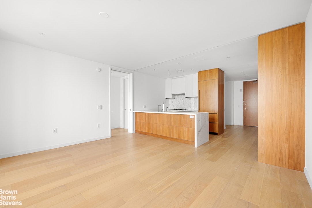 1 West End Avenue, Unit 28H Manhattan, NY 10069 - Photo 4 of 20 a view of a room with a refrigerator and cabinet