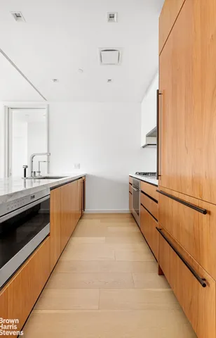 a kitchen with stainless steel appliances a sink and a refrigerator