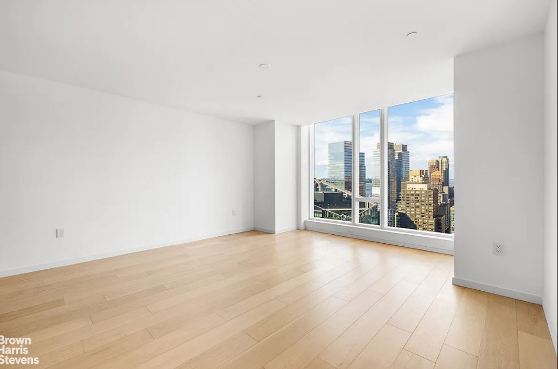 1 West End Avenue, Unit 28H Manhattan, NY 10069 - Photo 8 of 20 a view of a big room with wooden floor and windows