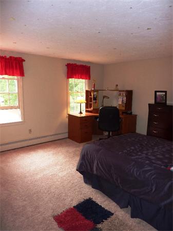 12 Nehemiah Road Shirley, MA 01464 - Photo 10 of 17 a bedroom with a bed and window