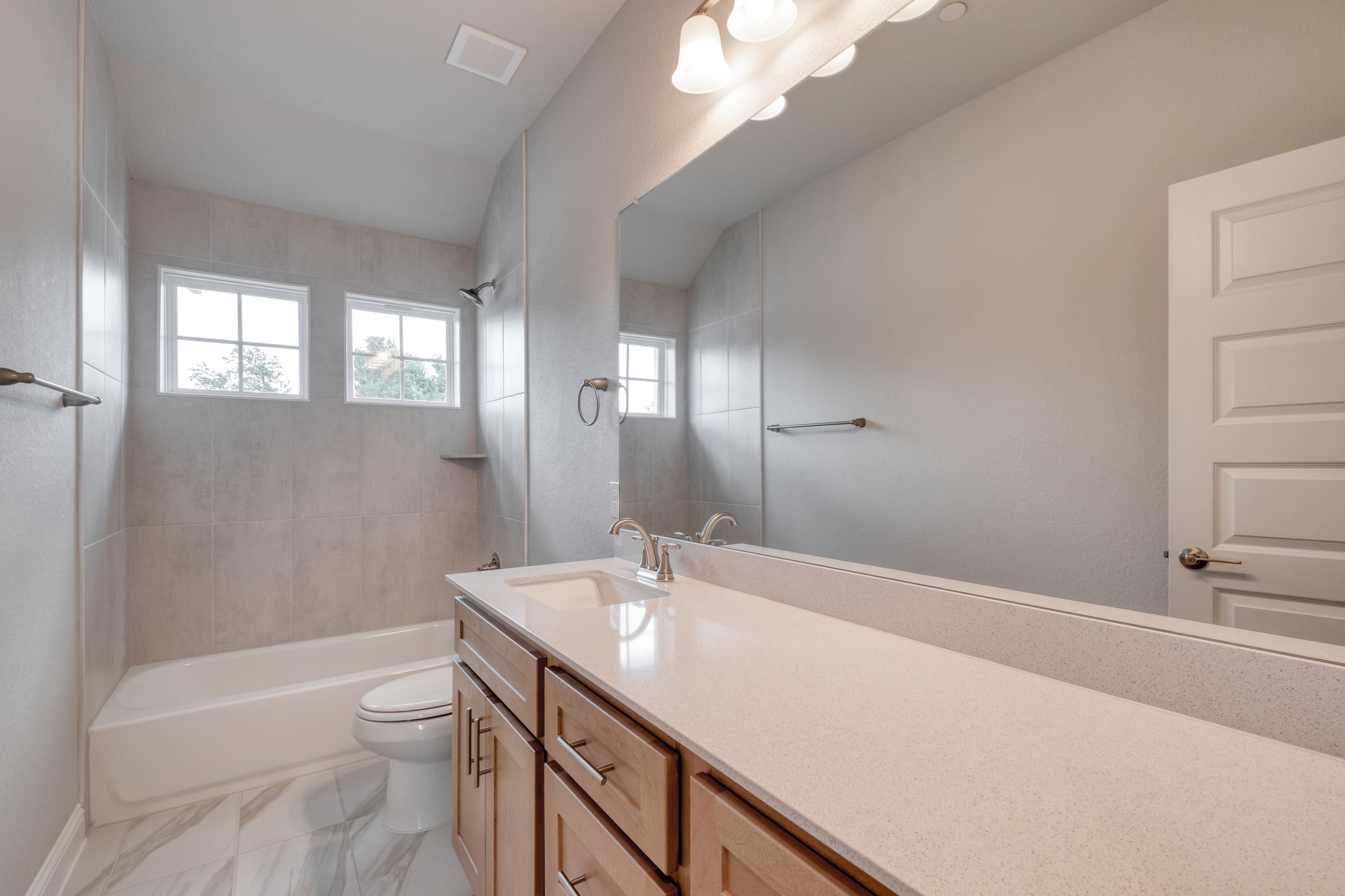 2605 Sam Bass Road, Unit 44 Round Rock, TX 78681 - Photo 22 of 26 A well-lit bathroom features a spacious vanity and pristine tile work.
