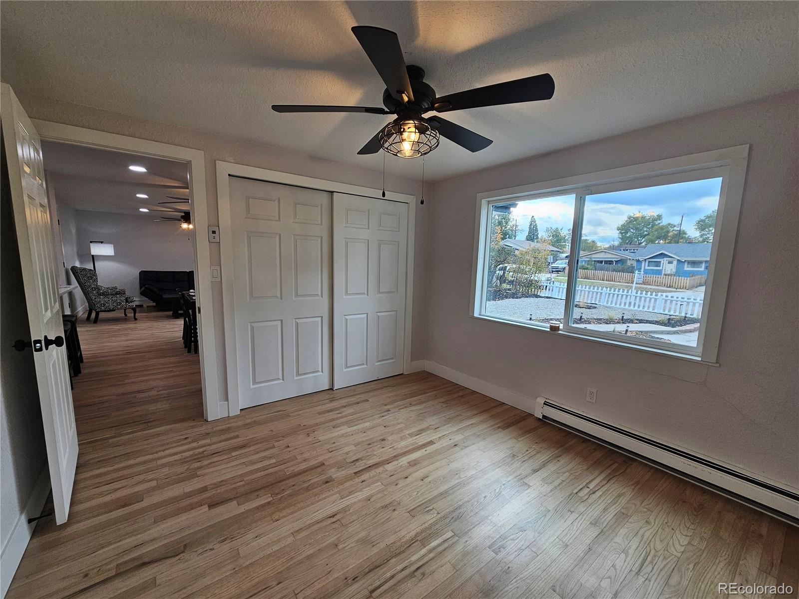124 South Grove Street Denver, CO 80219 - Photo 11 of 25 wooden floor in an empty room with a window