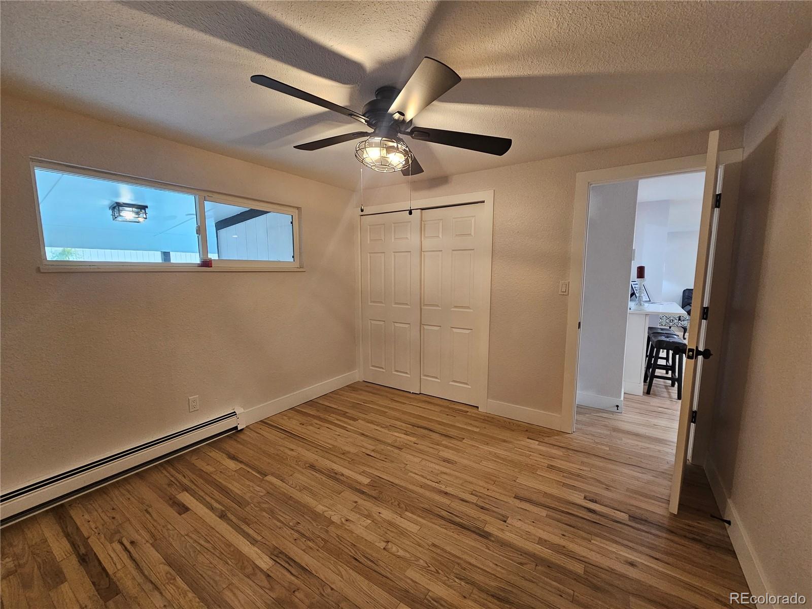 124 South Grove Street Denver, CO 80219 - Photo 13 of 25 a view of an empty room with wooden floor