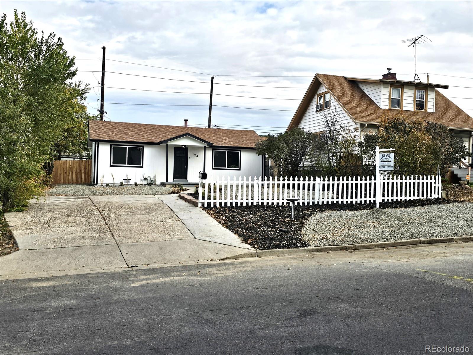 124 South Grove Street Denver, CO 80219 - Photo 2 of 25 a front view of a house with a garden