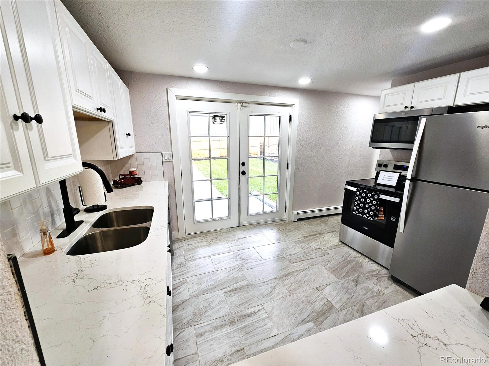 124 South Grove Street Denver, CO 80219 - Photo 4 of 25 a view of kitchen and windows