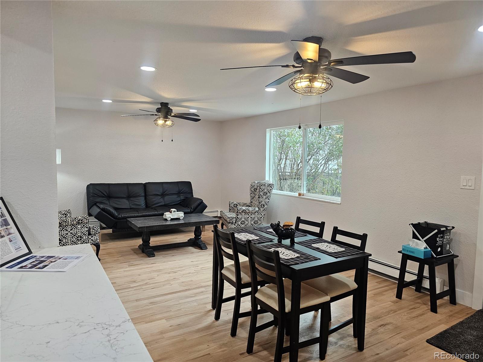 124 South Grove Street Denver, CO 80219 - Photo 9 of 25 a living room with furniture a window and a chandelier