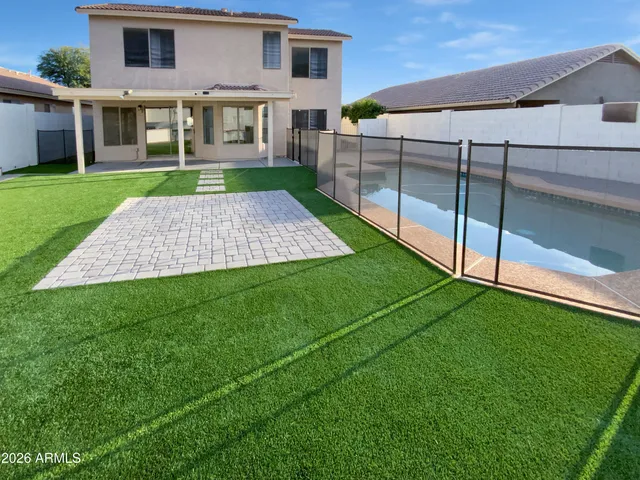 a view of house with backyard