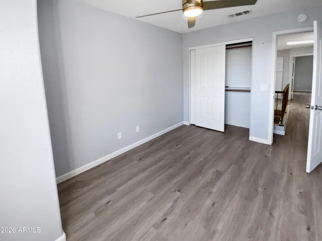an empty room with wooden floor and a window