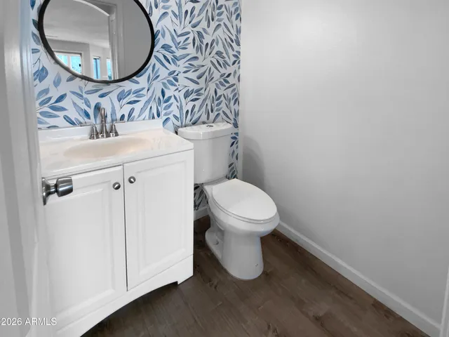 a white toilet sitting next to a bathroom sink