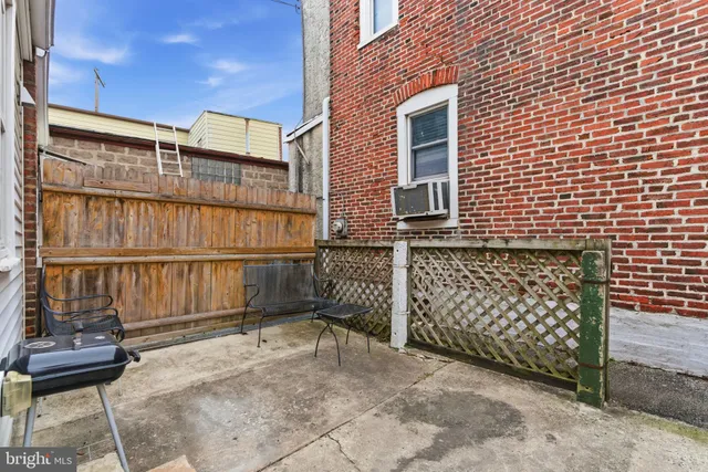 a view of a brick house with a large window