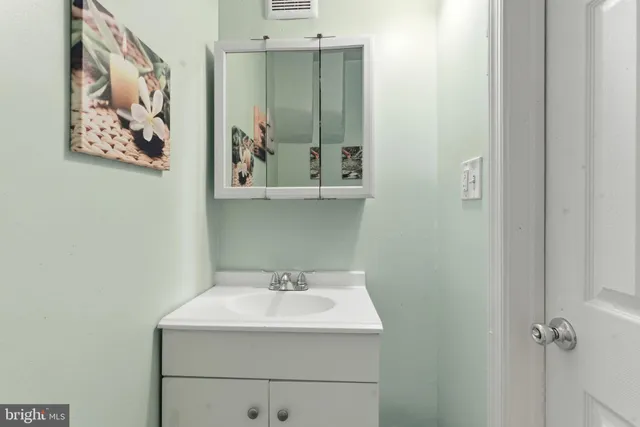 a bathroom with a sink and mirror