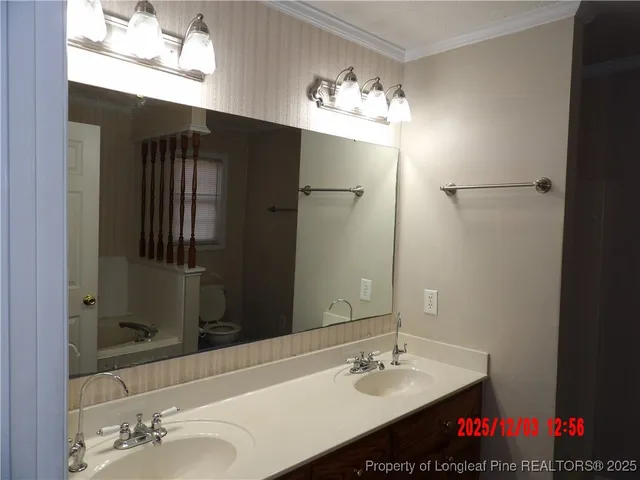 a bathroom with a sink vanity and a mirror