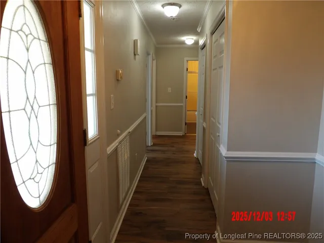 a view of hallway with wooden floor