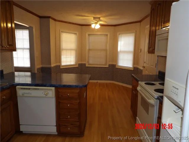 a kitchen with a sink a window and cabinets